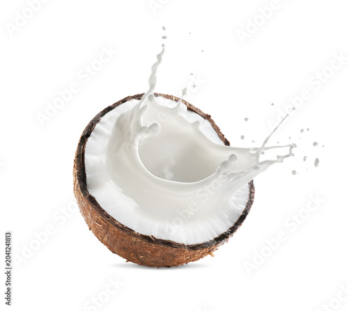 Fotografie Coconut milk splashing out of nut isolated on white