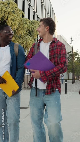 Diverse group of university students walking together outside campus