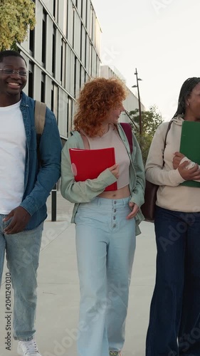 Diverse group of university students walking on campus together