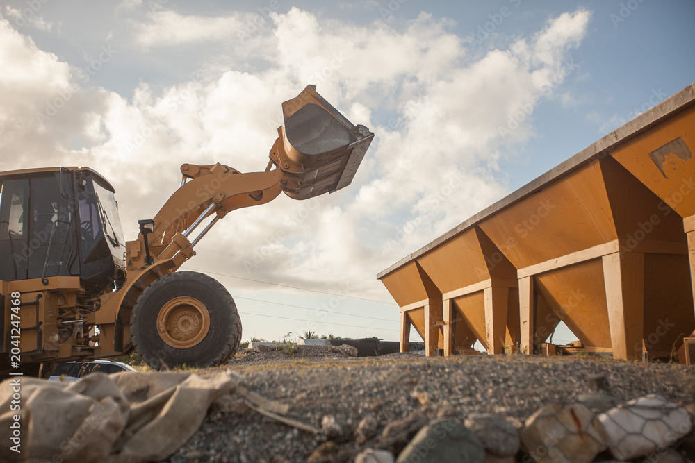 Fototapeta premium Heavy wheel loader machine working at an industrial construction or mining site