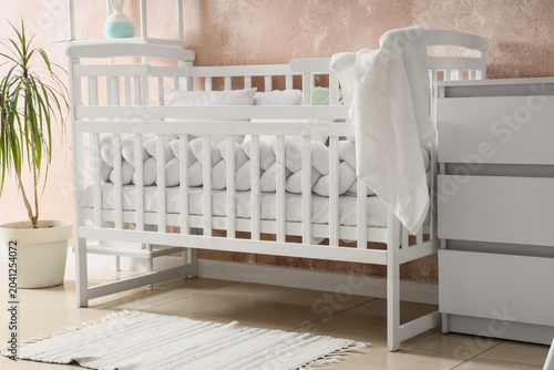 White crib near pink grunge...