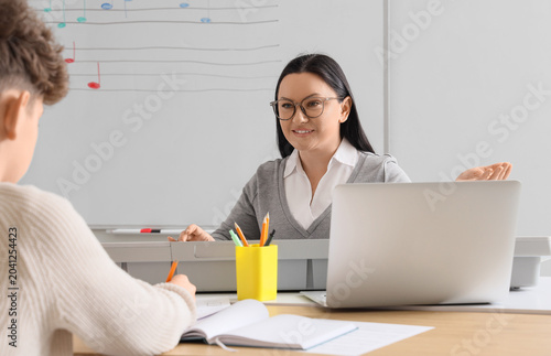 Female music teacher giving...