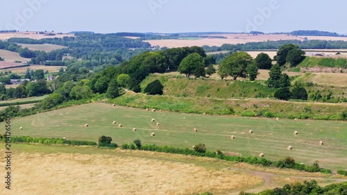Telephoto tracking aerial shot of Old Sarum ramparts and historic hill fort, Salisbury, UK