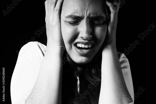 Stressed young woman on dar...