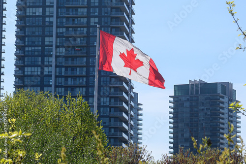 Photography Canadian flag waves proudly in Toronto city buildings