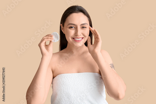Happy young woman in towel ...
