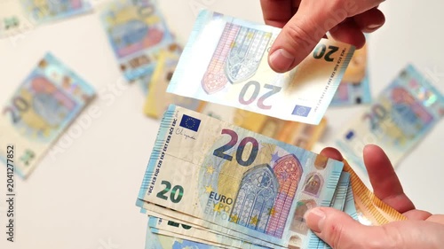 Income and Expenses in EU Countries. mans hands scatter Euro banknotes against a light background. Monetary Expenses, Costs, and Purchases.Salaries and Benefits in the European Union. 4k footage