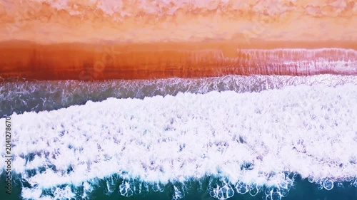 Beautiful sea summer landscape, Waves sea water surface High quality video Bird's eye view, Drone top view waves crashing on sand beach,Nature ocean sea beach background