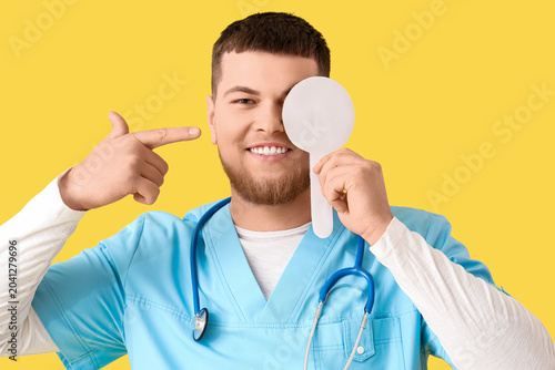 Male ophthalmologist pointi...