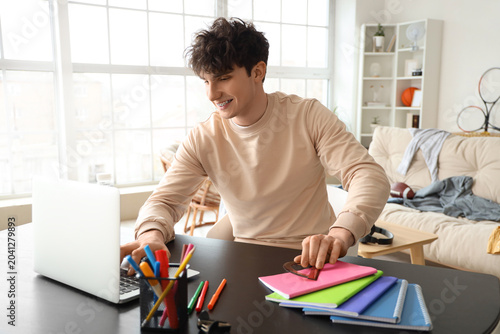 Male student studying with ...