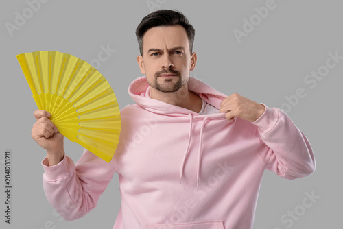 Young man with fan in hoodi...