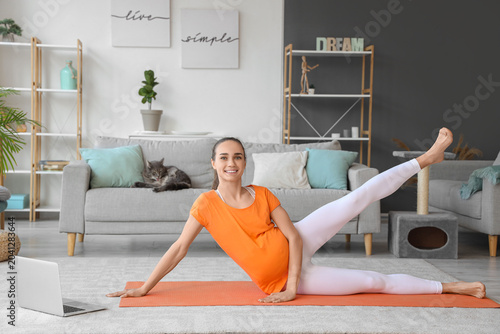 Young pregnant woman doing ...
