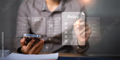 Compliance manager reviewing digital policy documents and governance procedures through online management system to improve regulatory compliance, operational control, security standards