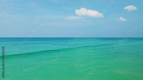 Aerial view of beautiful sea water background in summer day and sun reflections,Aerial flying drone view ocean background, Waves water surface,Flight over the ocean,Top view fly over the sea