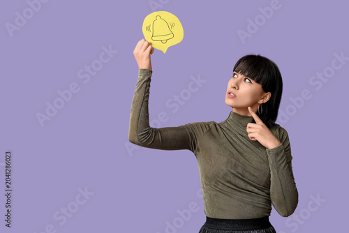 Pretty young woman holding ...