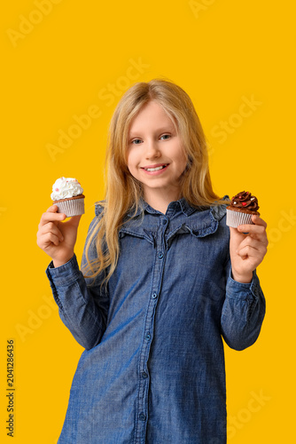 Cute little girl holding cu...