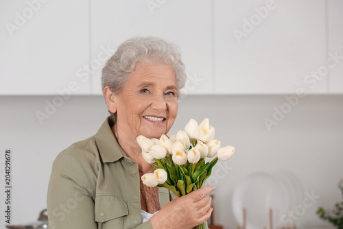 Senior woman with tulips in...