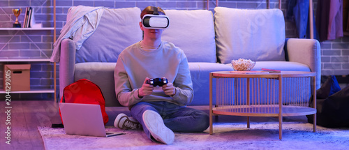 Male student in VR glasses ...