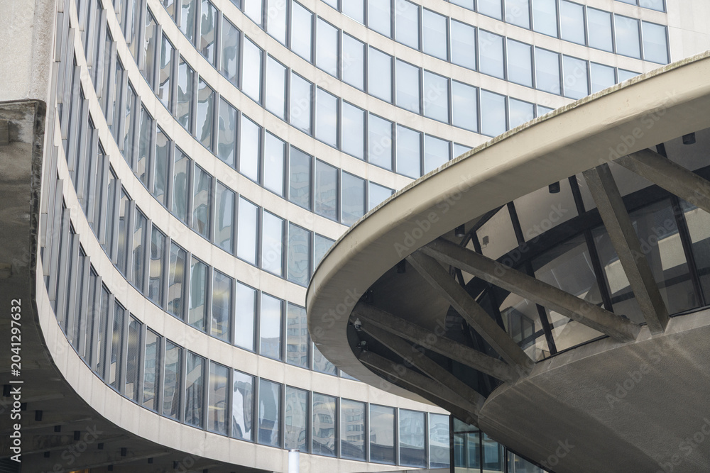 Naklejka premium Toronto City Hall (100 Queen St W), designed by architect Viljo Revell in the Modernist style, features twin curved concrete towers cradling a central, saucer-shaped council chamber