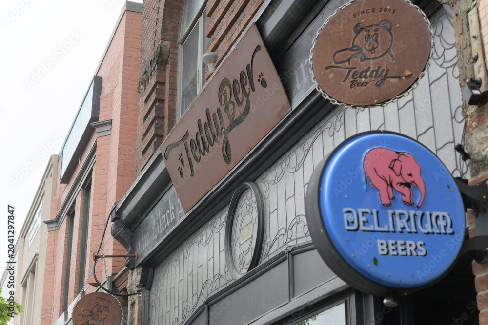 Naklejka premium exterior building facade and signage outside Teddy Beer, a bar, located at 928 Bloor St W, Toronto