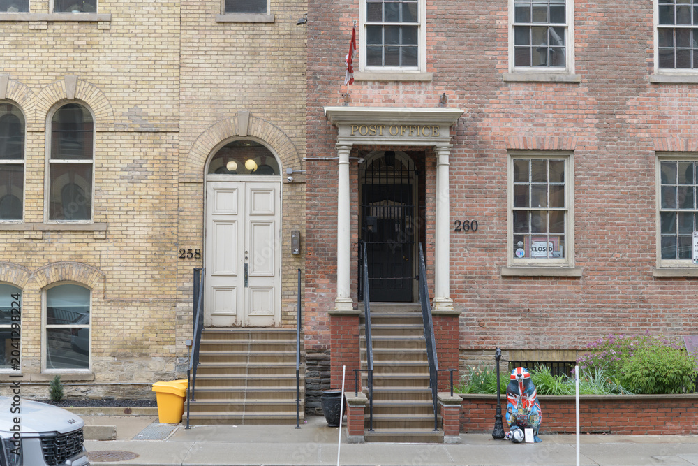 Naklejka premium historic building (258 Adelaide E) and Toronto's First Post Office, a local history museum, located at 260 Adelaide St E
