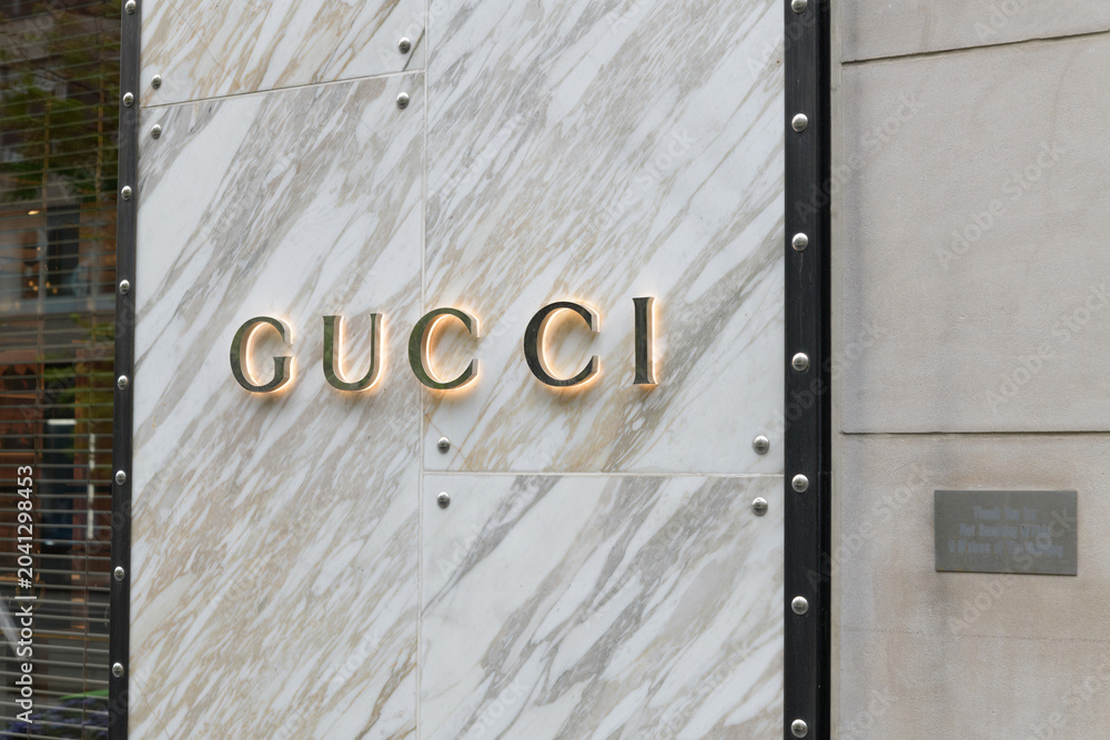 Naklejka premium sign outside Gucci, a luxury brand boutique, located at 130 Bloor St W, Toronto