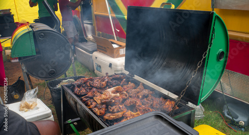 Εκτύπωση καμβά Jerk Chicken Grilling on Open Smoker at Outdoor Caribbean Food Festival