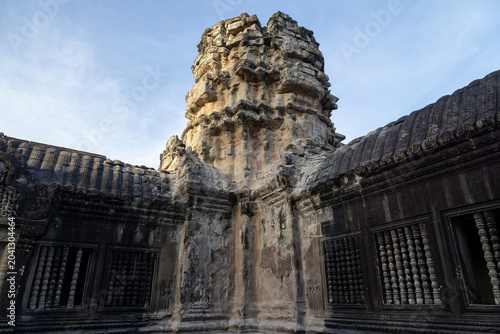 Konstfotografi The ancient Angkor Wat temple complex in Siem Reap, Cambodia, showcases intricate stone carvings and architectural grandeur under a clear blue sky