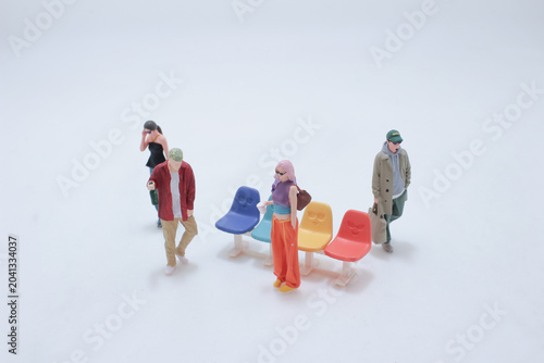 Miniature people waiting colorful bench scene