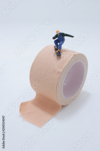 Miniature skateboard on medical tape roll