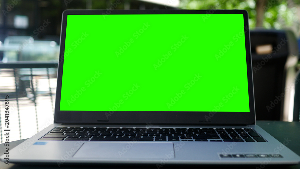 Fototapeta premium Timelapse of Green Screen Laptop in a Business Office Park Setting