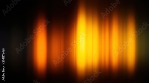 Abstract blurred flames in warm hues of orange and yellow.