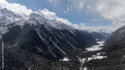 Tableau sur toile Aerial panoramic winter scenery of snow mountain valley in Bailang Valley, Nying