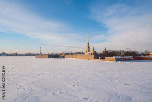 Peter and Paul Fortress and Vasilievsky Island from the Trinity Bridge over the Neva River on a sunny winter morning with clouds, St. Petersburg, Russia