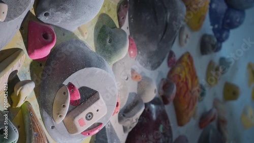 Extreme close-up, hand grabs the ledge, clings to the fingers. Breaks off the ledge, failure. Strong experienced athlete practices bouldering wall climbing inside a gym. Sports lifestyle. Slow motion