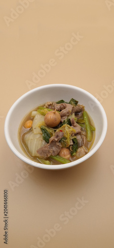 Thai Isan style herbal soup with chicken offal, egg ovaries and dill, traditional food.