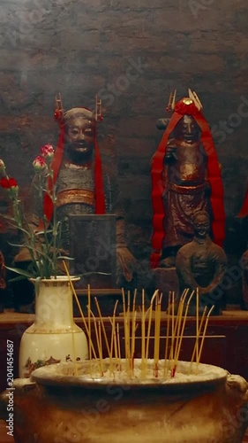 Ambient motion of rising incense smoke in an altar for ancestor worship decorated in reds during the Lunar New Year in Man Mo Temple in Shen wang, Hong Kong