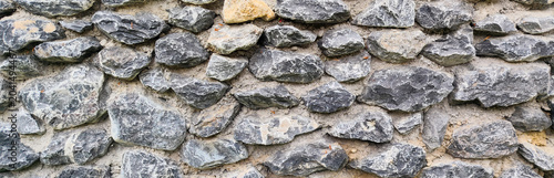 Fényképezés Ancient stone wall texture background with grey stones for medieval architectura