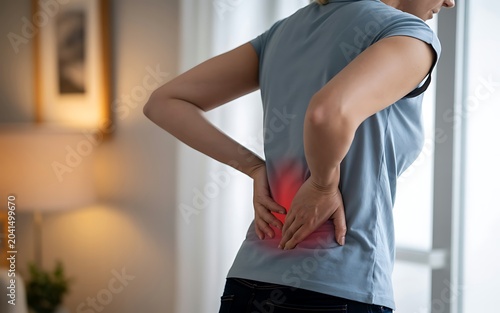 Woman with lower back pain highlighted spine inflammation ache discomfort healthcare.