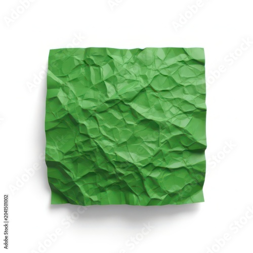 A square shaped piece of crumpled green paper with sharp edges and rough texture