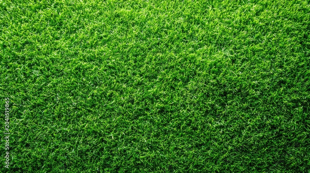 Obraz premium A close-up overhead view of lush, vibrant artificial green grass blades