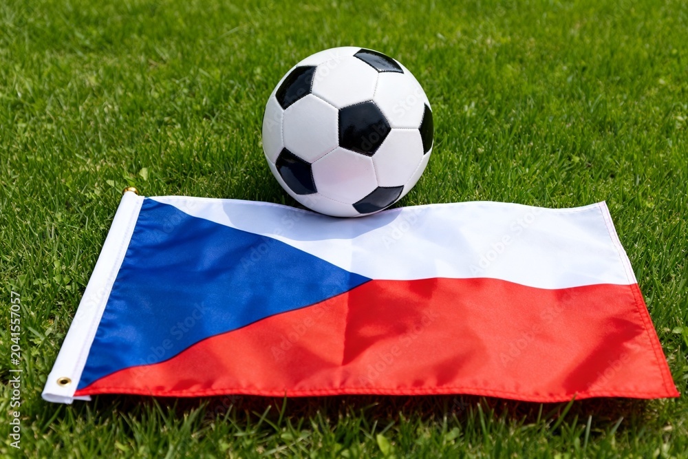 Naklejka premium Czech Flag and Soccer Ball on Green Grass