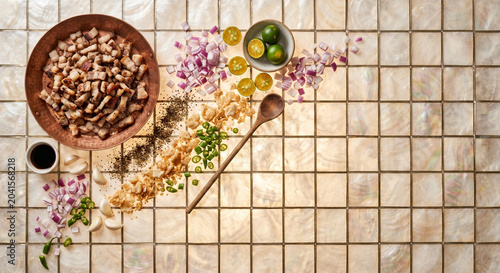 Flat lay of Sisig ingredients on Capiz shell, copy space