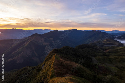 Landscape of Morning Mist with Mountain Layer. mountain ridge and clouds in rural jungle bush forest