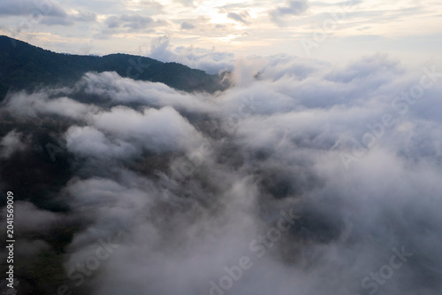Landscape of Morning Mist with Mountain Layer. mountain ridge and clouds in rural jungle bush forest
