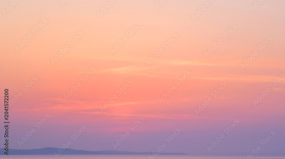 Obraz premium Beautiful sunset sky with soft pastel colors, shades of orange, pink and purple over a calm sea with a distant coastline silhouette
