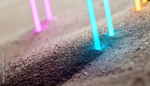 Macro shot of glowing neon light bars inserted into a dark textured asphalt or soil surface