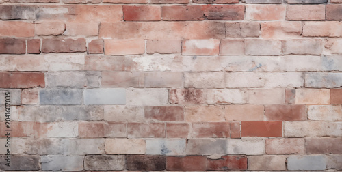 Rustic multicolored brick wall texture featuring warm earth tones and weathered grout lines