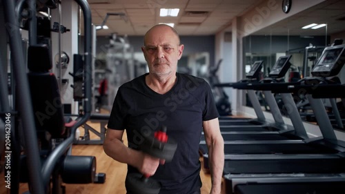 Senior Man Lifting Dumbbell in Gym Showing Strength, Fitness and Healthy Aging