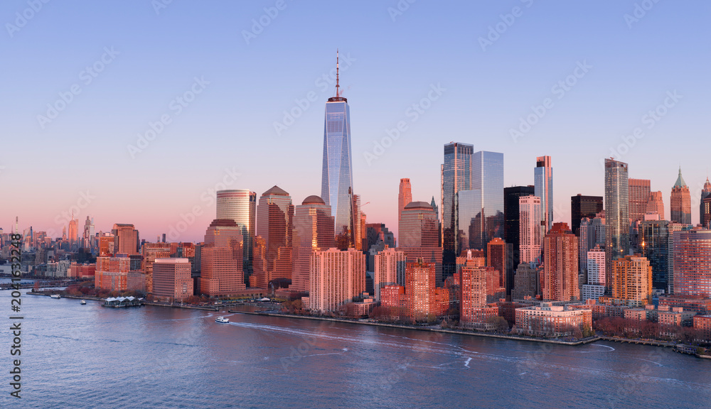 Fototapeta premium New York skyline with Tower in panoramic dusk view. NYC panoramic landscape at dusk. New York City wide panoramic skyline at dusk. New York aerial panoramic view of Manhattan skyscrapers.